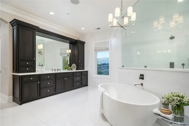 a kitchen with a table chairs and flat screen tv