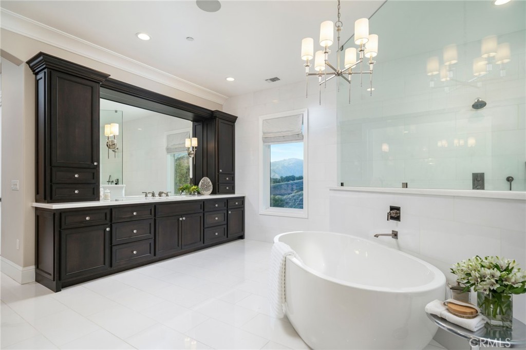 4485 Broken Spur Road La Verne, CA 91750 - Photo 36 of 75 a spacious bathroom with a double vanity sink a large mirror and a bathtub