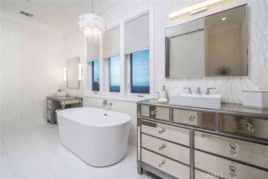 4485 Broken Spur Road La Verne, CA 91750 - Photo 42 of 75 a bathroom with a sink a large mirror and a bathtub