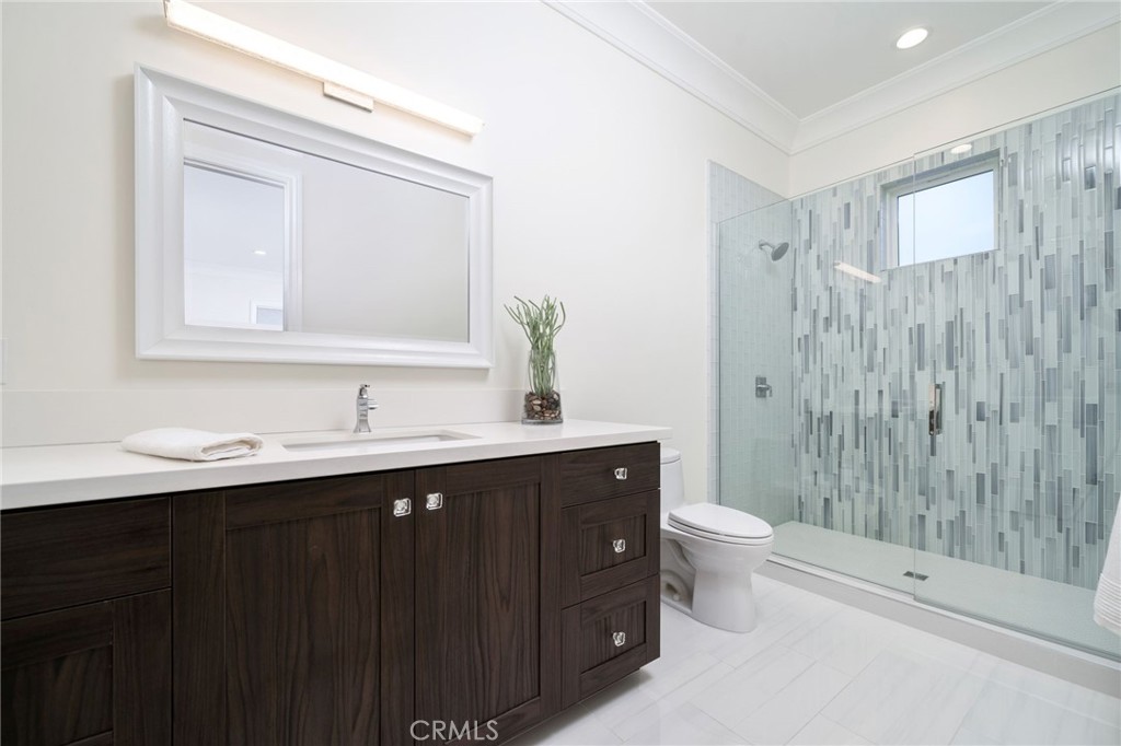4485 Broken Spur Road La Verne, CA 91750 - Photo 45 of 75 a bathroom with a double vanity sink toilet mirror and shower