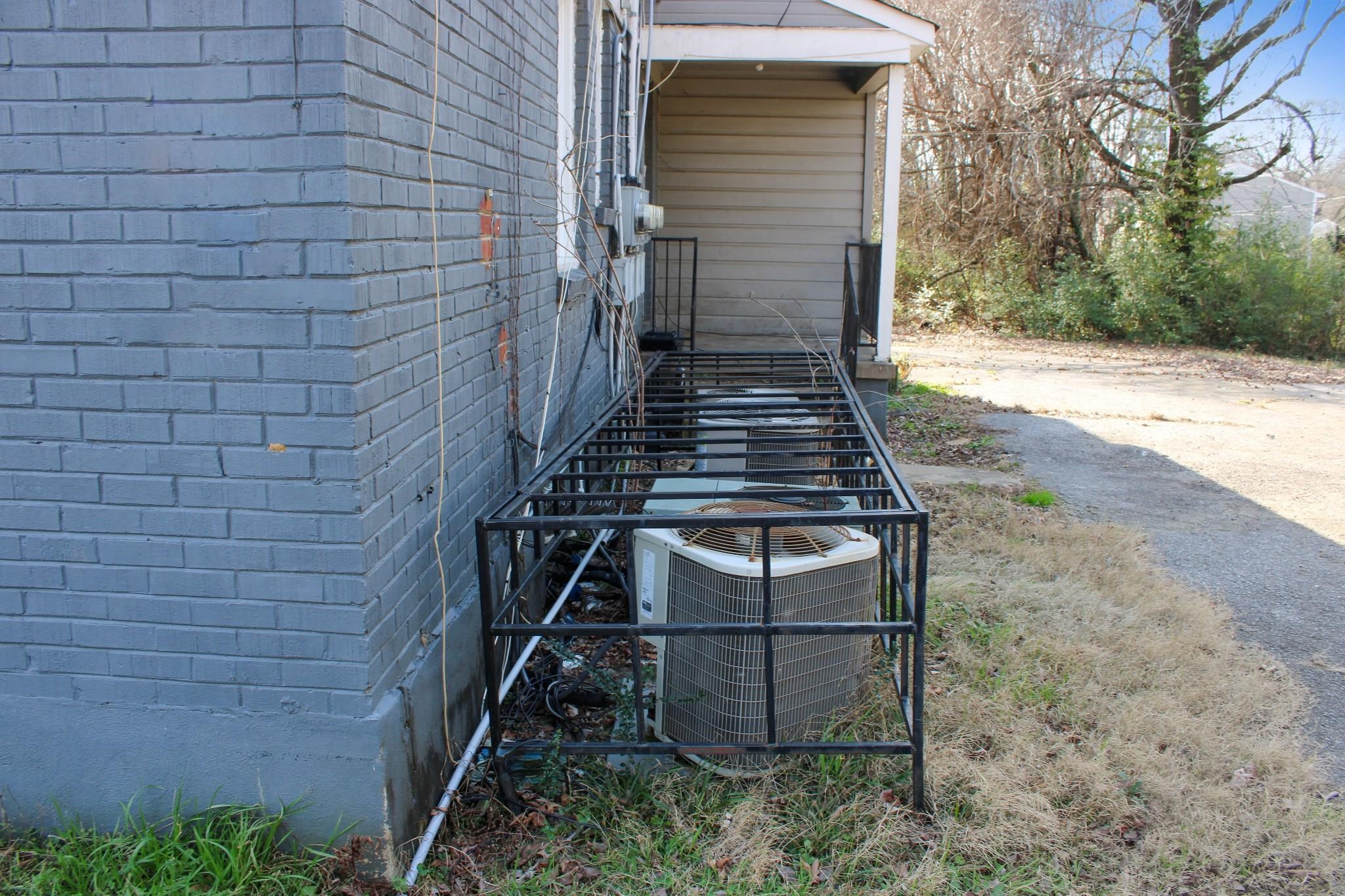 1203 Aubra Road Memphis, TN 38111 - Photo 3 of 10 View of side of property with brick siding and a central air condition unit
