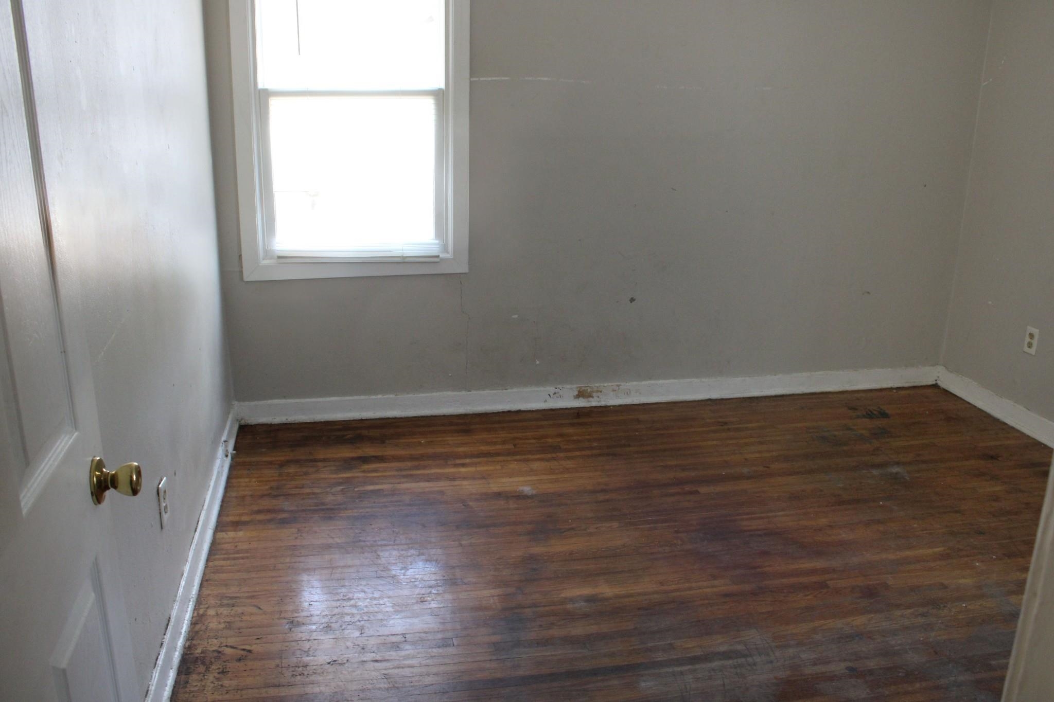 1203 Aubra Road Memphis, TN 38111 - Photo 8 of 10 Spare room featuring dark wood finished floors and baseboards