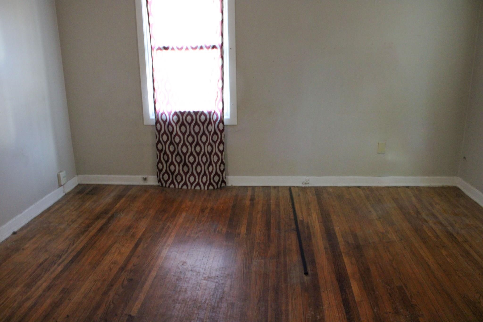 1203 Aubra Road Memphis, TN 38111 - Photo 9 of 10 Empty room with dark wood-type flooring and baseboards
