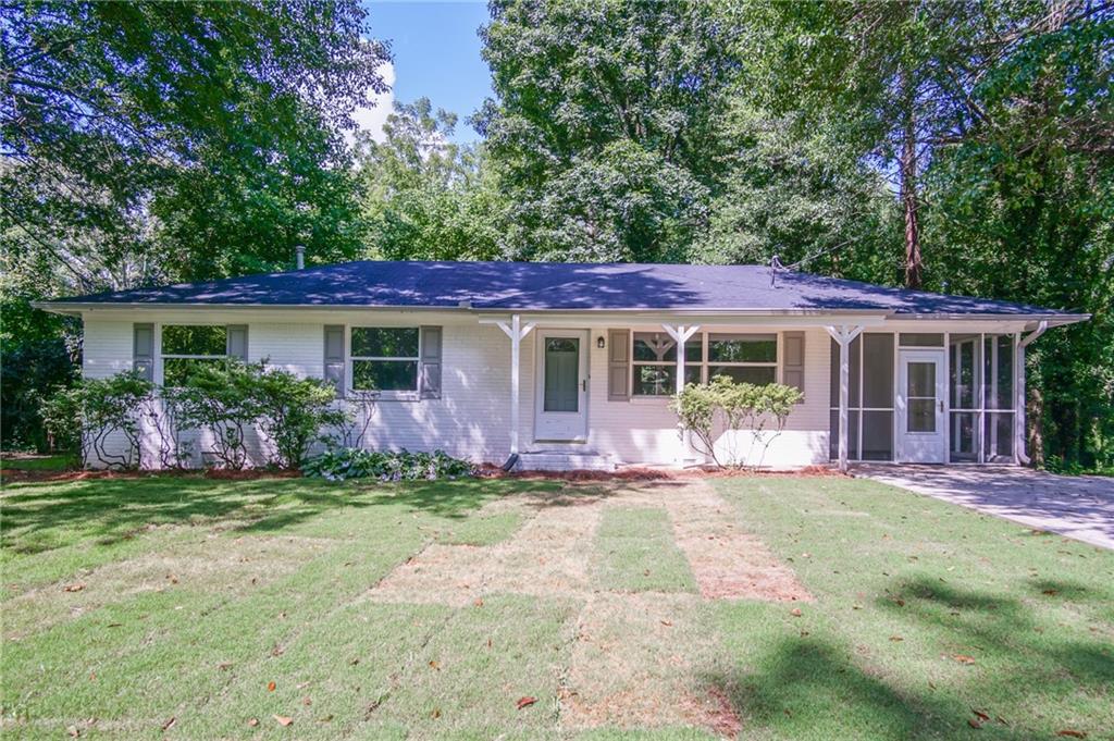 5942 Ridge Drive Southeast Mableton, GA 30126 - Photo 1 of 1 Ranch-style home with a sunroom and a front lawn