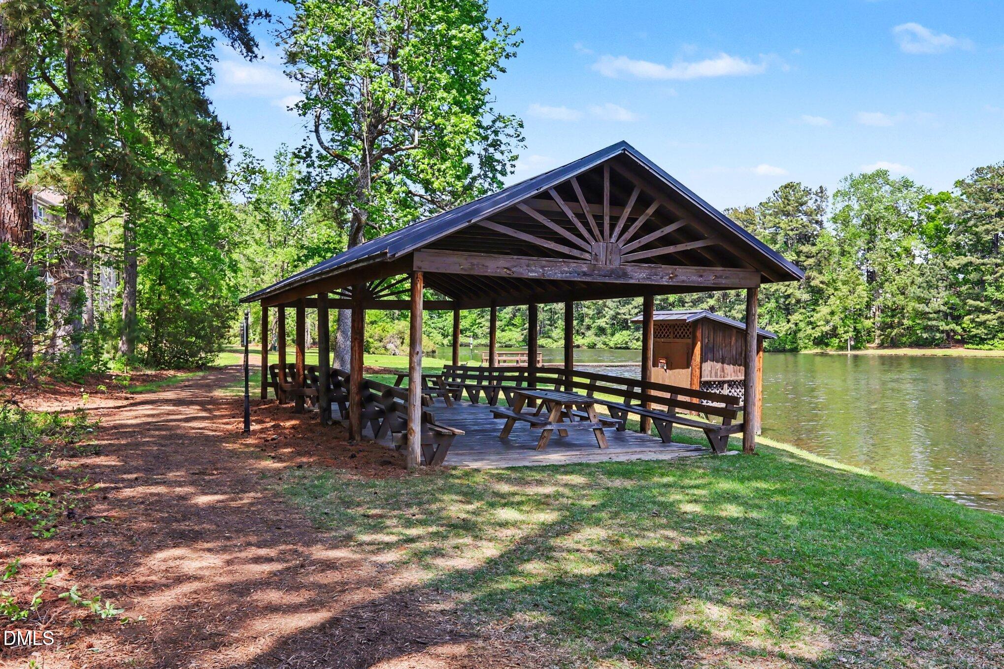 2409 Memory Ridge Drive Raleigh, NC 27606 - Photo 30 of 36 a patio with wooden table and chairs