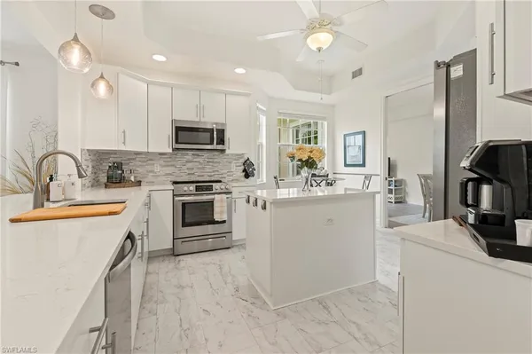a kitchen with a sink stove and refrigerator
