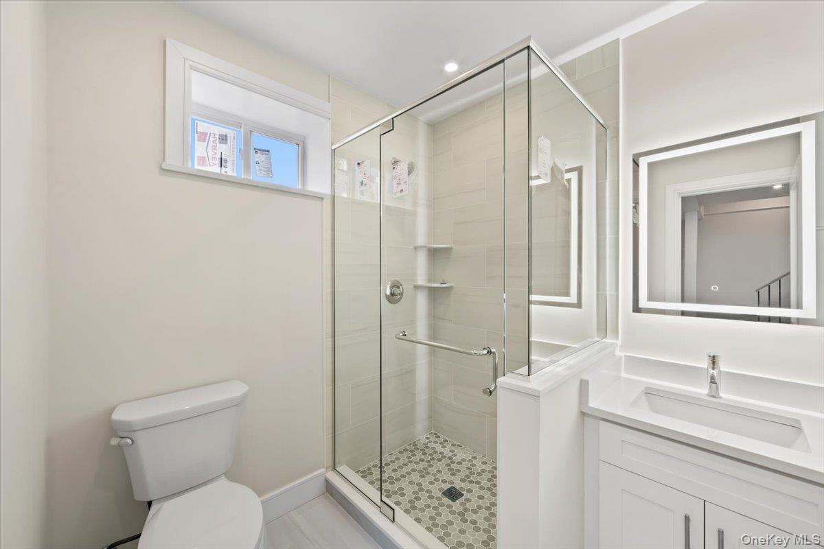395 5th Avenue New Rochelle, NY 10801 - Photo 21 of 26 a bathroom with a granite countertop sink toilet and shower