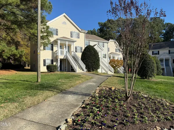 a view of a white house with a yard