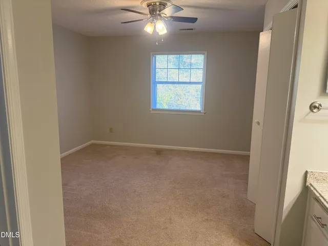a view of an empty room with a fan