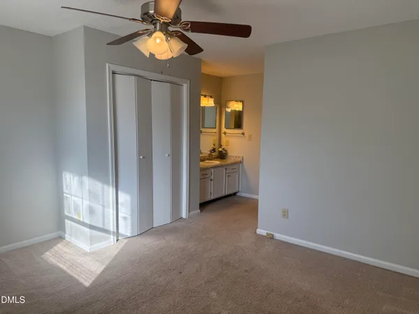 a view of room with window and ceiling fan