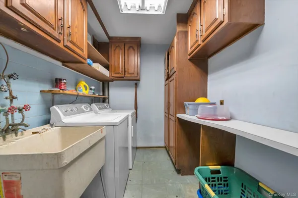 a utility room with a sink a washer and dryer