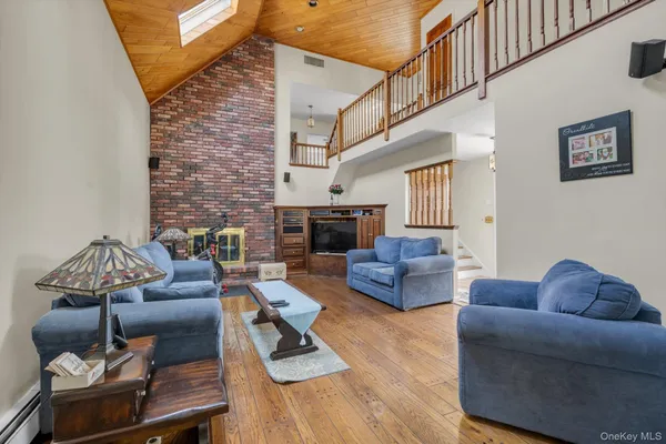 a living room with furniture fireplace and a ceiling fan