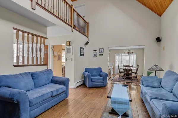 a living room with furniture or couch and a wooden floor