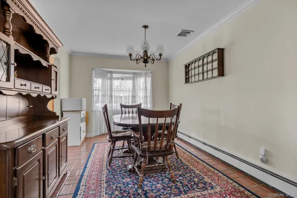 a view of a dining room with furniture and a chandelier