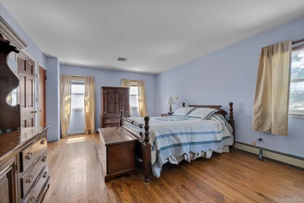 a spacious bedroom with a bed and a large window
