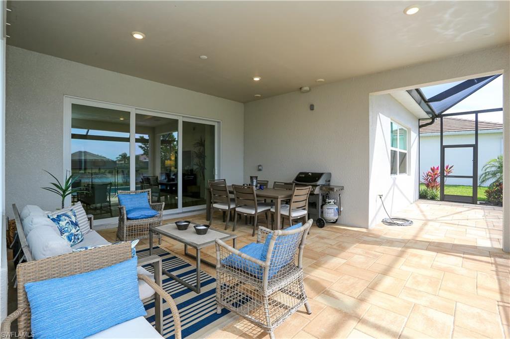 14656 Kelson Circle Naples, FL 34114 - Photo 11 of 50 a living room with furniture a rug and a floor to ceiling window