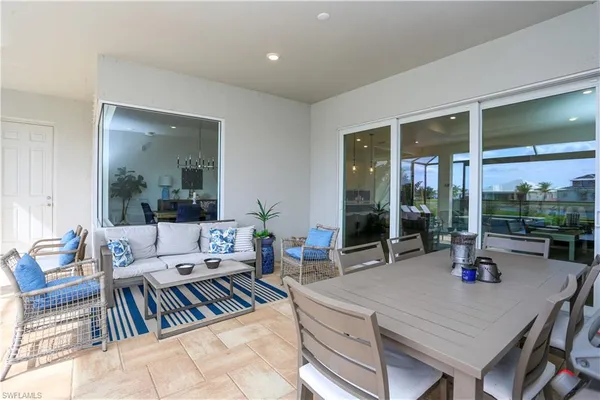 a living room with furniture large window and table