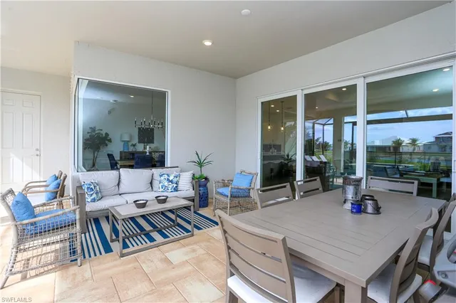 a living room with furniture large window and table