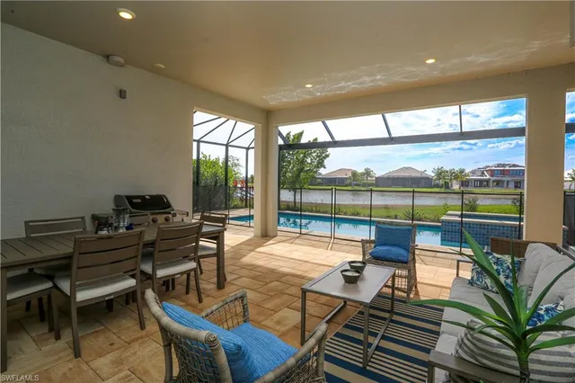 a living room with furniture and a floor to ceiling window