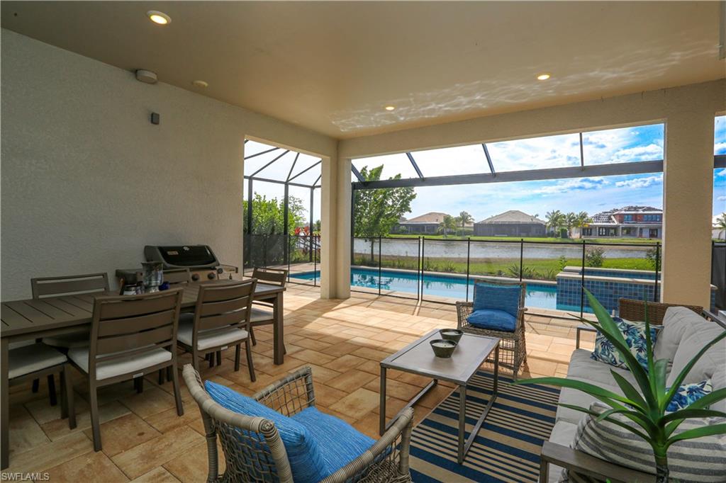 14656 Kelson Circle Naples, FL 34114 - Photo 14 of 50 a living room with furniture and a floor to ceiling window