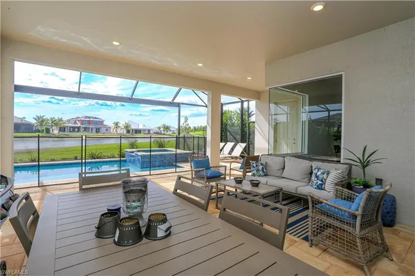 a living room with furniture and floor to ceiling windows