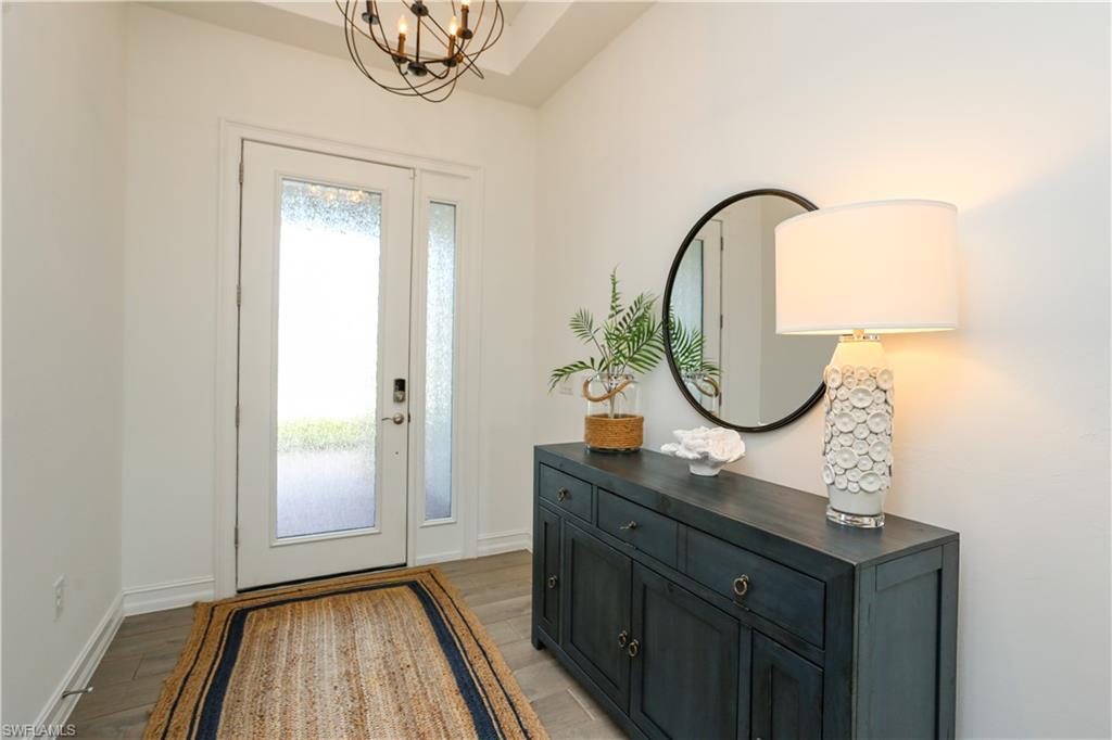 14656 Kelson Circle Naples, FL 34114 - Photo 16 of 50 a bathroom with a sink a mirror and a shower