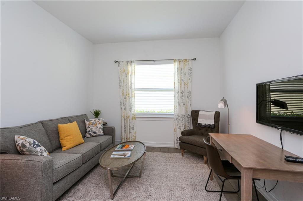 14656 Kelson Circle Naples, FL 34114 - Photo 22 of 50 a living room with furniture and a flat screen tv