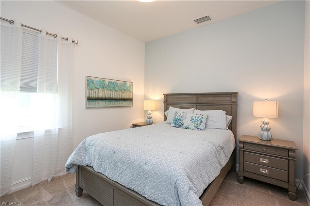 14656 Kelson Circle Naples, FL 34114 - Photo 28 of 50 a bedroom with a bed and a window