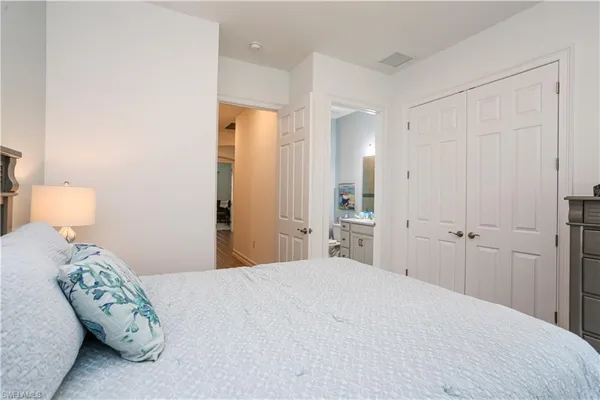 a bedroom with a bed and a lamp