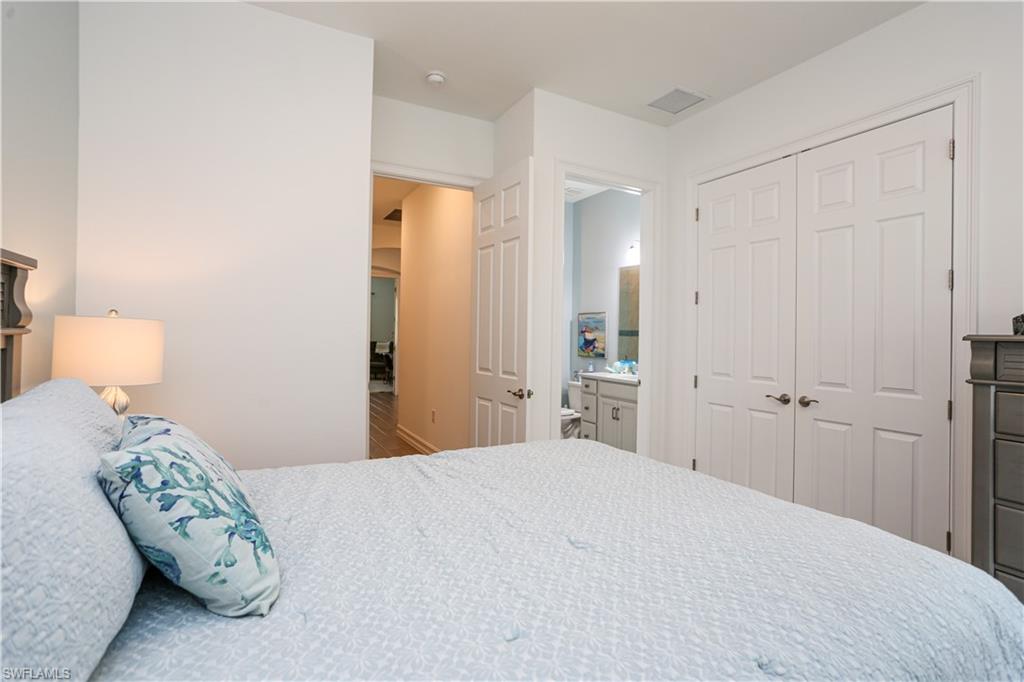 14656 Kelson Circle Naples, FL 34114 - Photo 29 of 50 a bedroom with a bed and a lamp