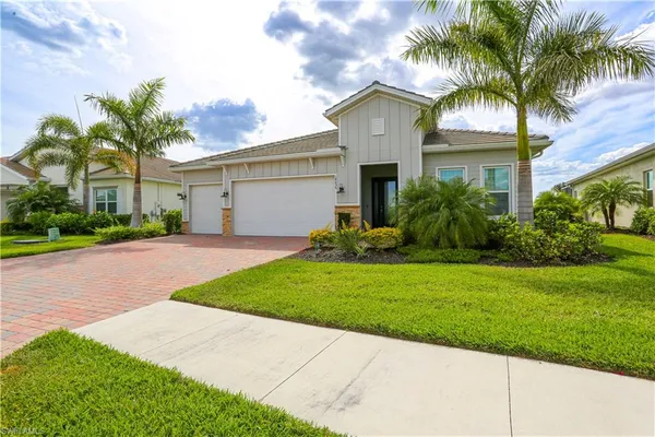 a front view of house with yard and green space