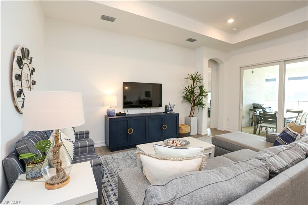 14656 Kelson Circle Naples, FL 34114 - Photo 32 of 50 a living room with furniture and a flat screen tv