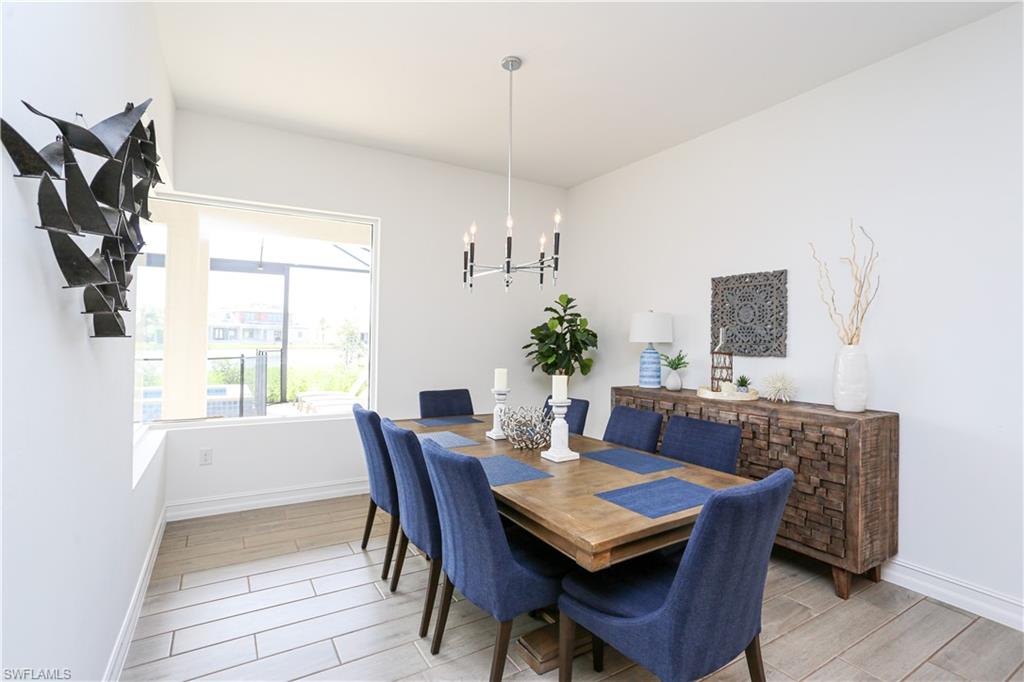 14656 Kelson Circle Naples, FL 34114 - Photo 36 of 50 a view of a dining room with furniture window and wooden floor
