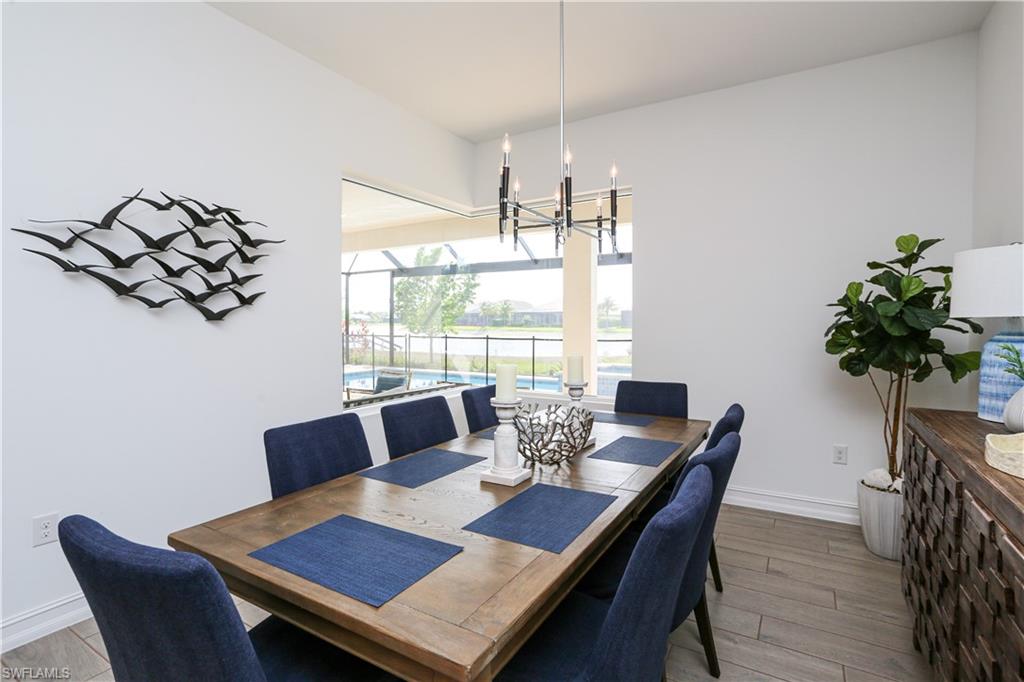 14656 Kelson Circle Naples, FL 34114 - Photo 37 of 50 a view of a dining room with furniture window and wooden floor