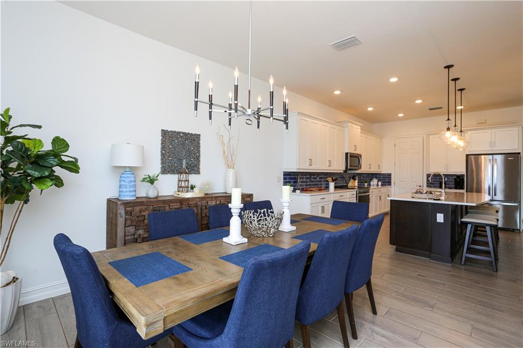 14656 Kelson Circle Naples, FL 34114 - Photo 39 of 50 a view of a dining room with furniture and wooden floor