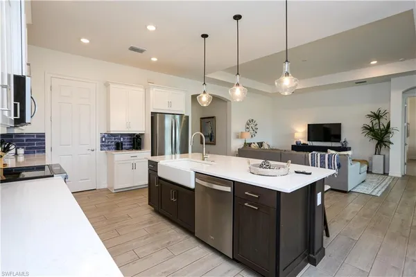 a large kitchen with stainless steel appliances a large center island and a stove