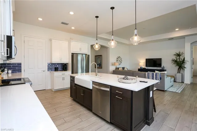 a large kitchen with stainless steel appliances a large center island and a stove