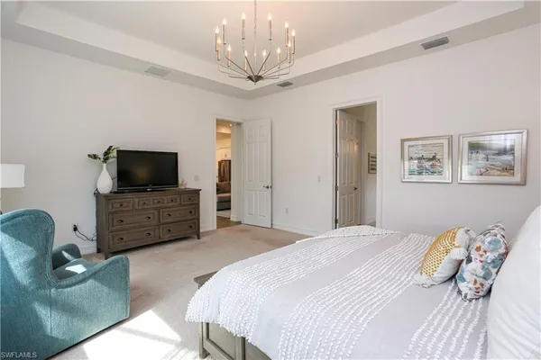 a bedroom with a bed and a television