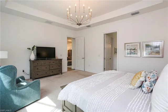 a bedroom with a bed and a television