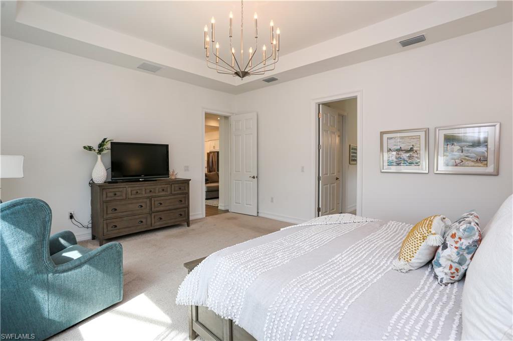 14656 Kelson Circle Naples, FL 34114 - Photo 46 of 50 a bedroom with a bed and a television