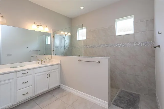 a bathroom with a double vanity sink and a mirror