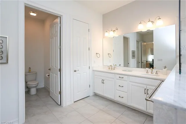 a spacious bathroom with a granite countertop sink mirror and toilet