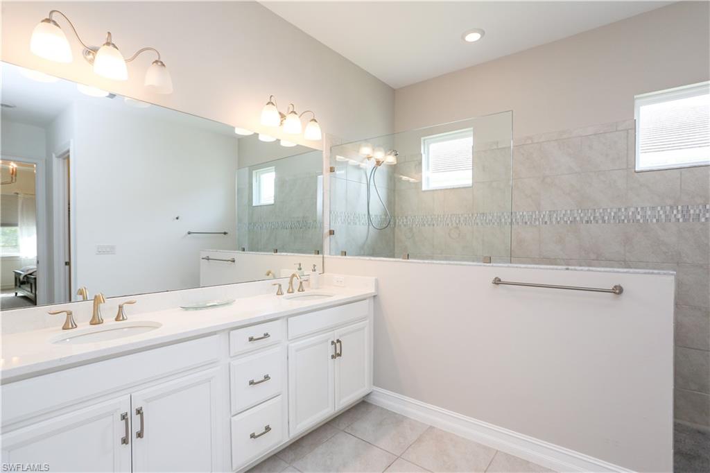 14656 Kelson Circle Naples, FL 34114 - Photo 50 of 50 a bathroom with a double vanity sink and a mirror