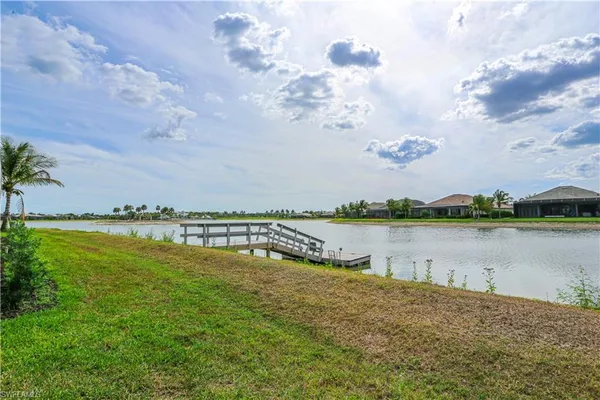 a view of a lake with houses in the back