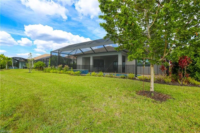 a backyard of a house with table and chairs