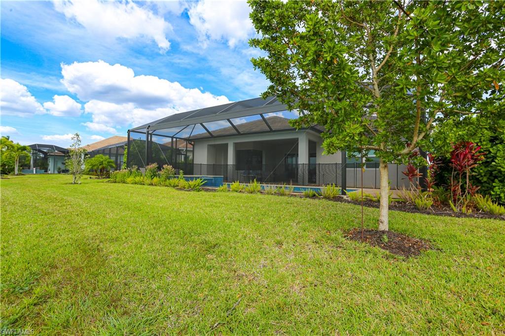 14656 Kelson Circle Naples, FL 34114 - Photo 6 of 50 a backyard of a house with table and chairs