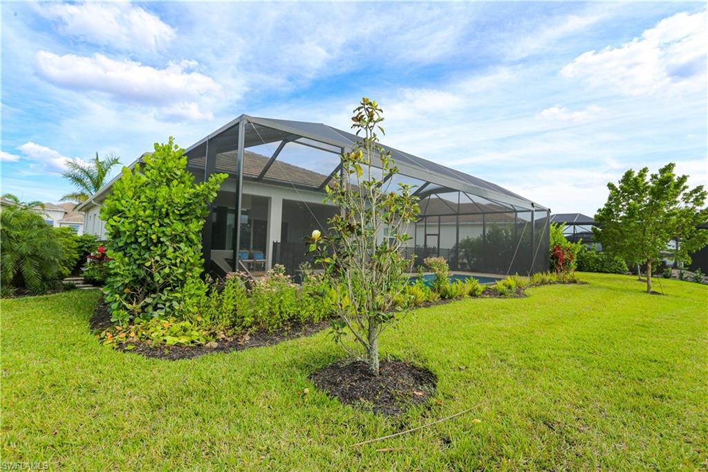 14656 Kelson Circle Naples, FL 34114 - Photo 7 of 50 a front view of a house with garden