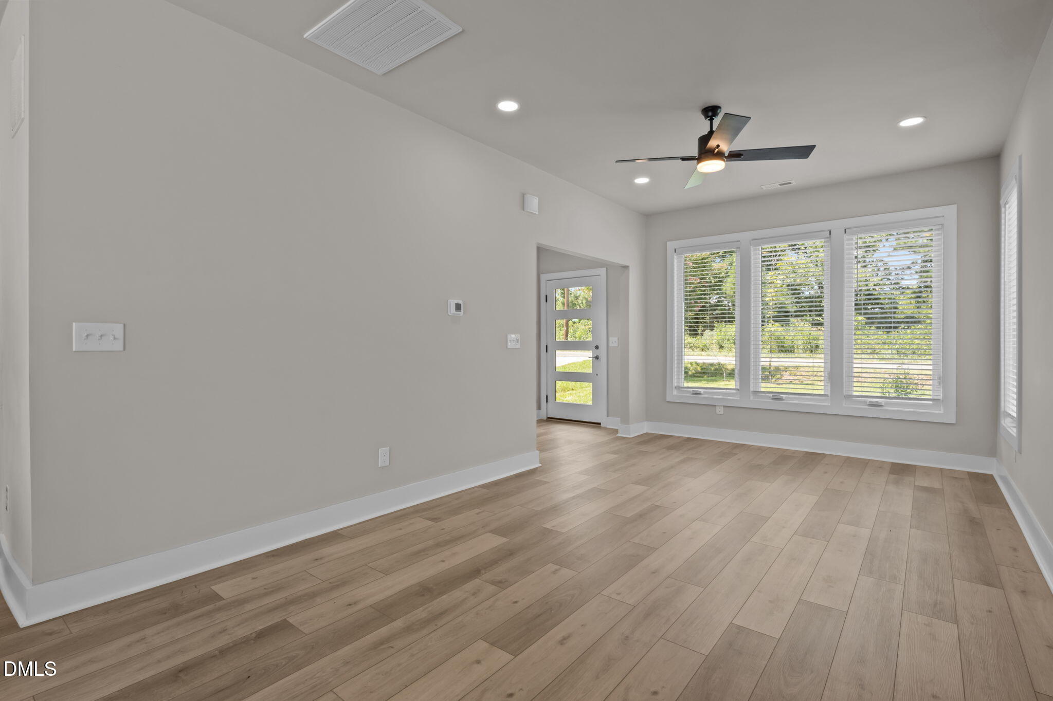 421 Eugene Street, Unit A Durham, NC 27701 - Photo 12 of 38 an empty room with wooden floor and windows