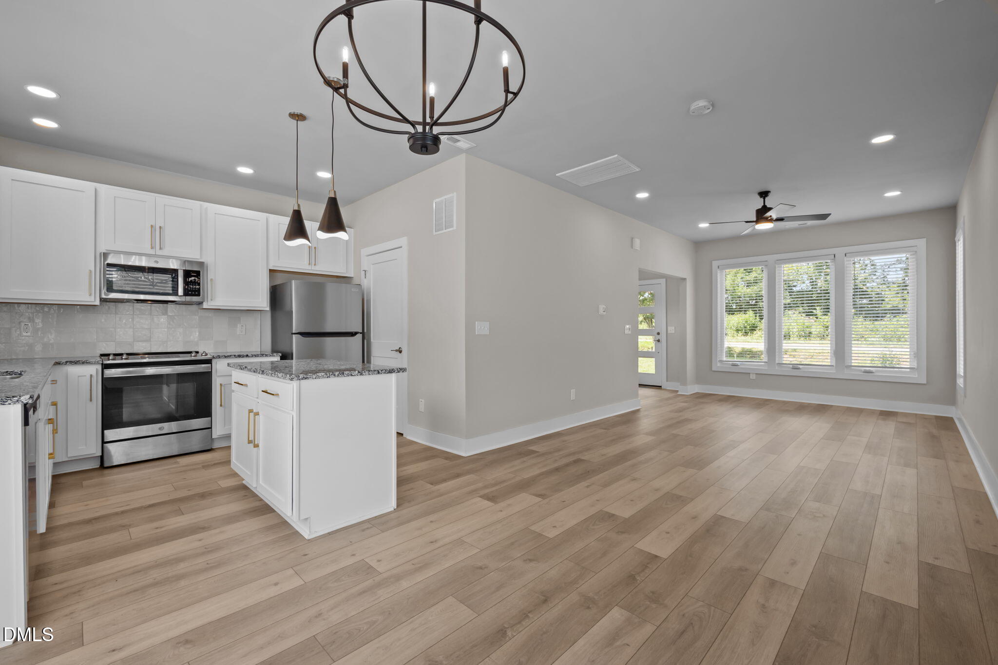 421 Eugene Street, Unit A Durham, NC 27701 - Photo 13 of 38 a large kitchen with stainless steel appliances granite countertop a stove a sink and a large refrigerator