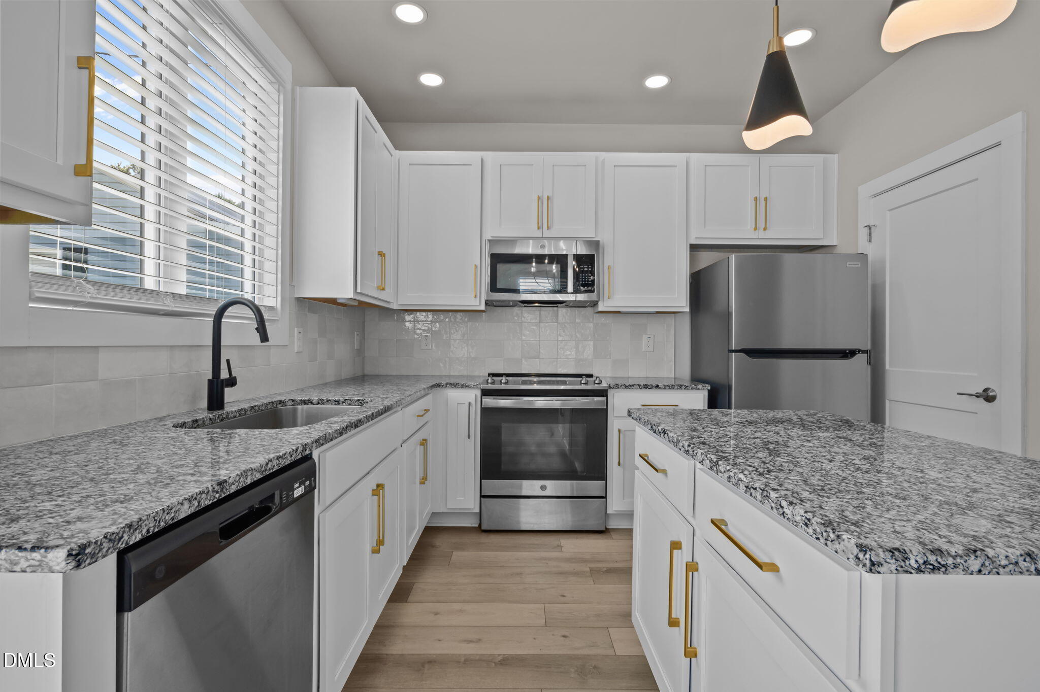 421 Eugene Street, Unit A Durham, NC 27701 - Photo 16 of 38 a kitchen with granite countertop a sink and a refrigerator